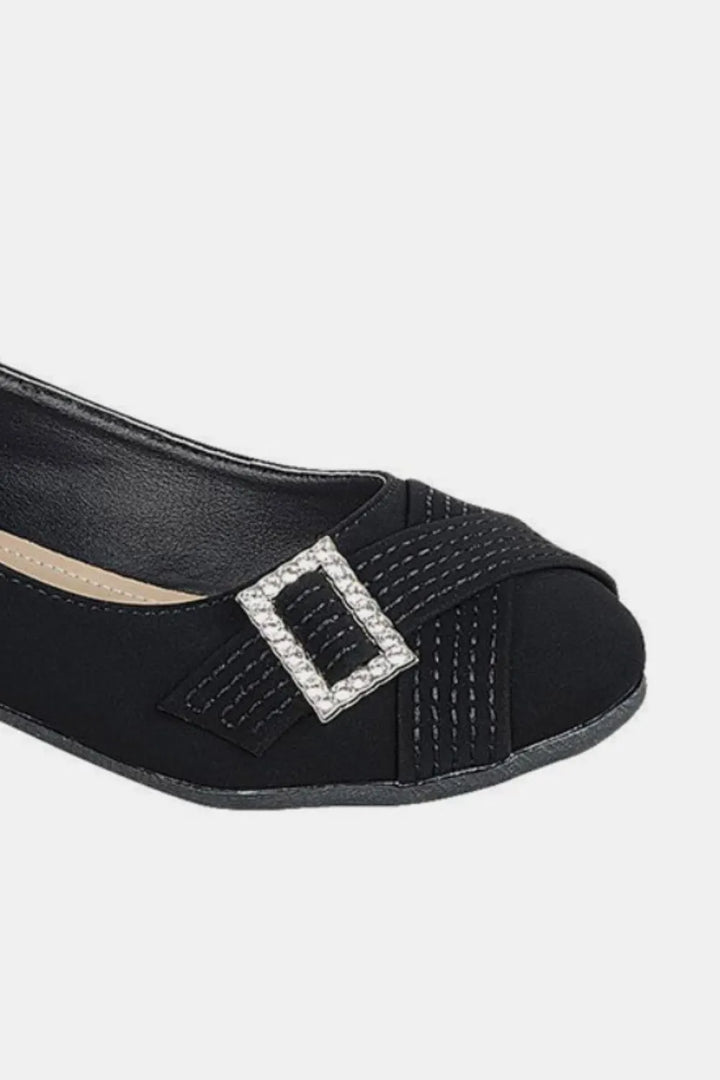 Black shoe with a decorative buckle