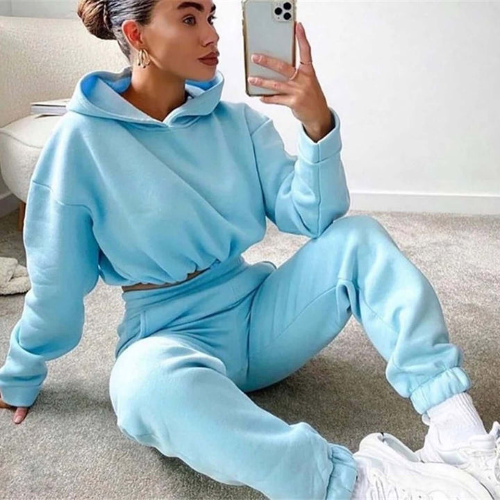 Stylish blue two-piece jogging suit for women, featuring a cozy hoodie and comfortable pants, perfect for casual fitness.