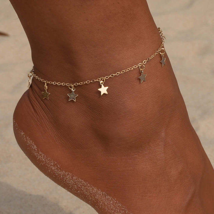 Gold star fashion anklet jewelry on a woman's ankle, perfect for stylish summer looks and special occasions.