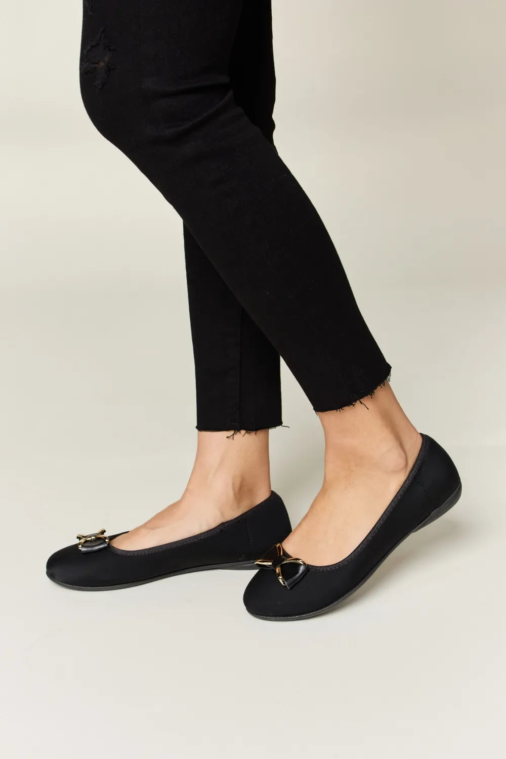 Black flats worn with black pants 