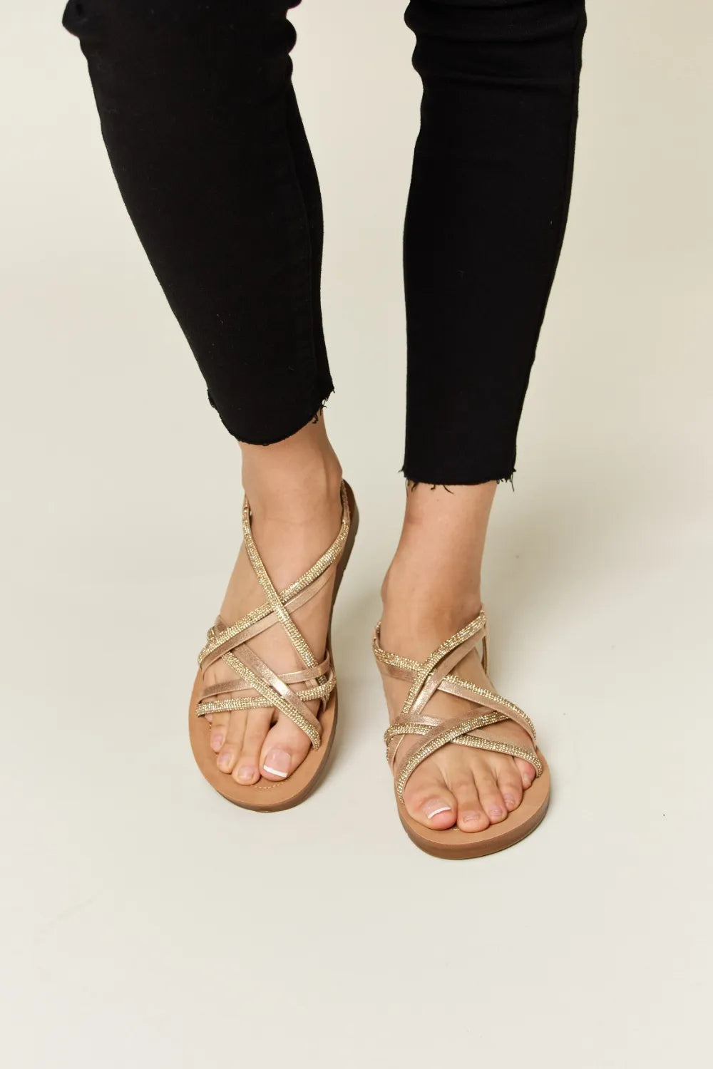 Beige sandals worn with black pants 