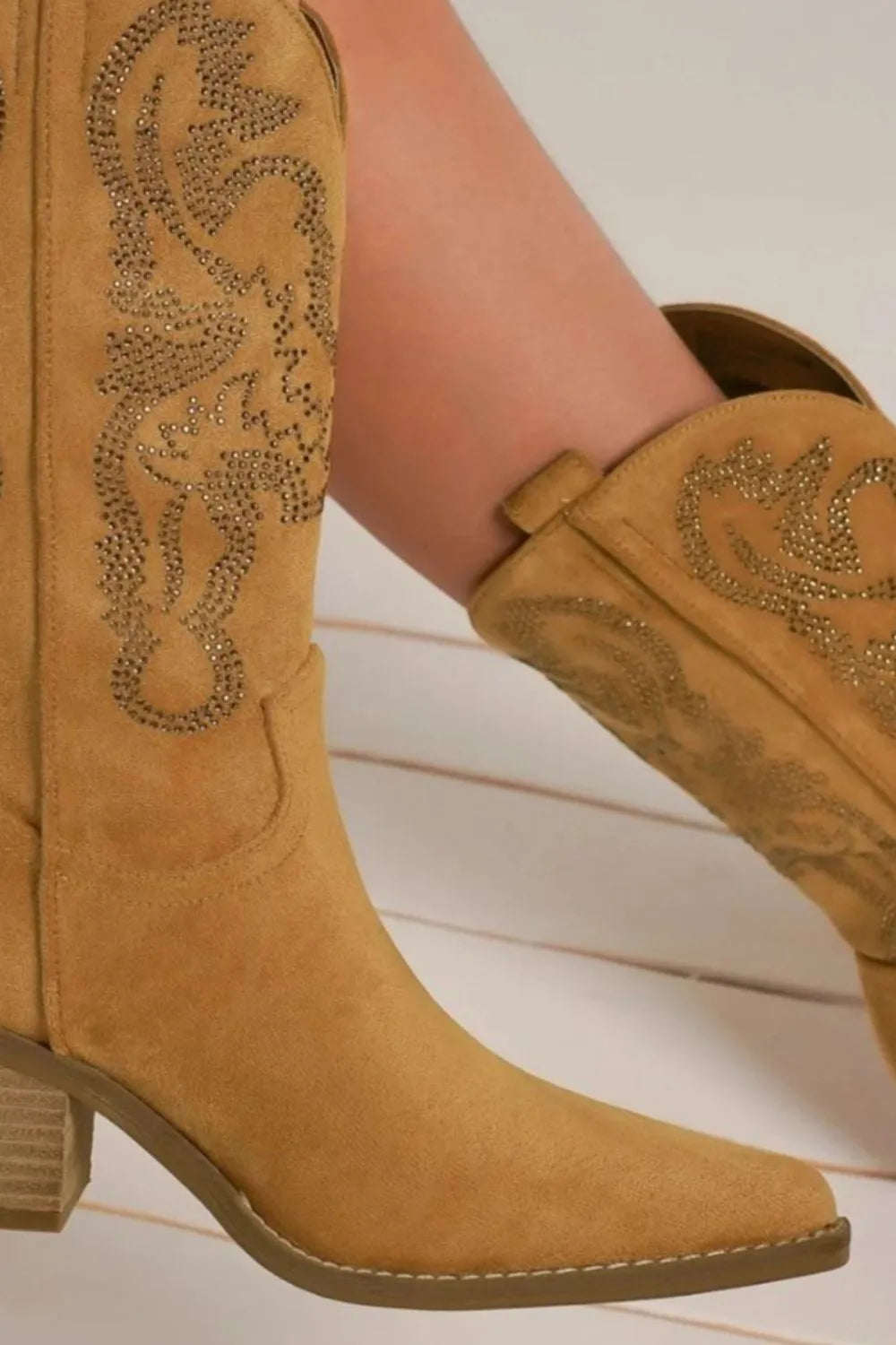 Tan cowboy boots with decorative patterns 