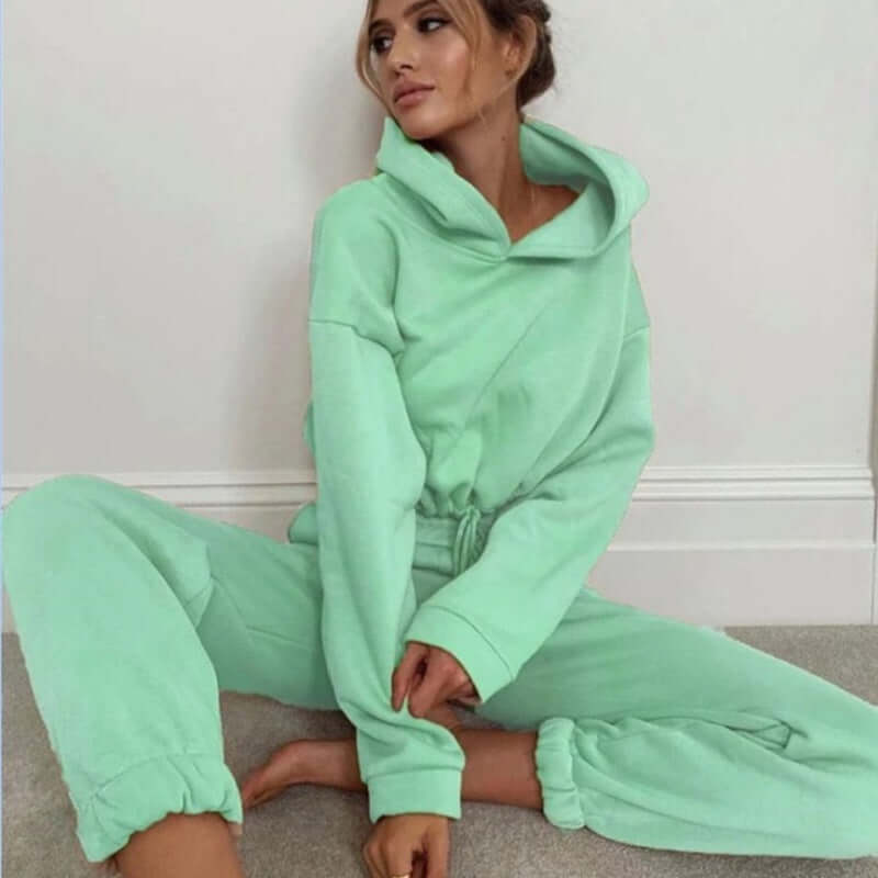 Stylish women's mint green jogging suit, featuring a long sleeve hoodie and elastic pants, perfect for casual fitness.