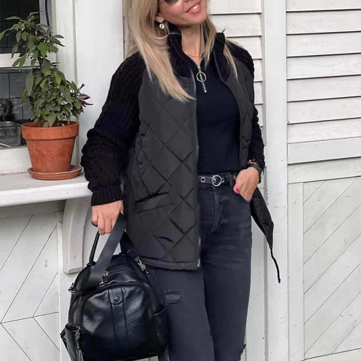 Stylish woman wearing a stand collar cotton jacket with pockets, black skinny jeans, and a handbag, outdoors.