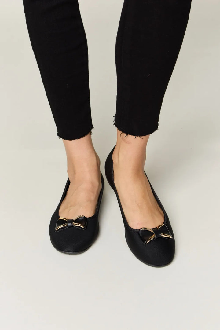 Black flats with gold accents 