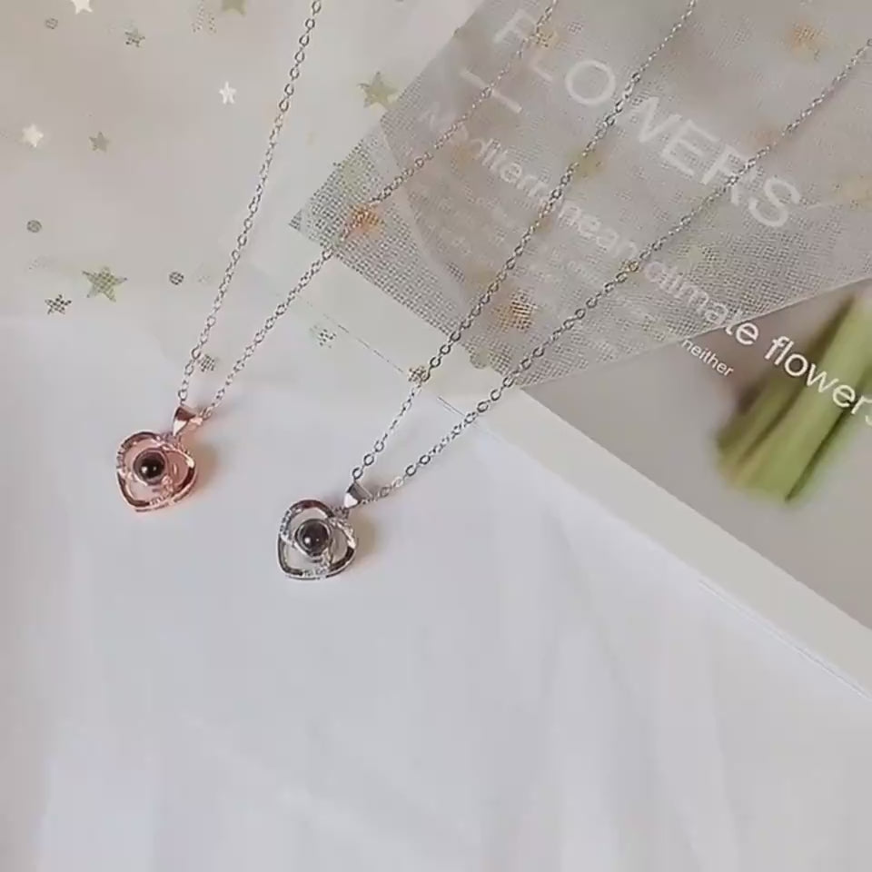 S925 silver heart-shaped photo projection necklaces in rose gold and silver, displayed on a soft background.